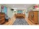 A large bedroom with hardwood floors, a decorative rug, and a comfortable bed is ready for a new owner at 3025 Mountain Creek Ne Ct, Roswell, GA 30075