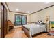 Bedroom featuring hardwood floors, neutral walls, and large window providing ample natural light at 3025 Mountain Creek Ne Ct, Roswell, GA 30075