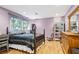 Well lit bedroom with hardwood floors, complemented by natural light and an area rug at 3025 Mountain Creek Ne Ct, Roswell, GA 30075