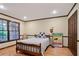 Bright bedroom with hardwood floors, complemented by natural light and a decorative area rug at 3025 Mountain Creek Ne Ct, Roswell, GA 30075