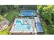 Aerial view of a community pool and tennis courts surrounded by trees at 3025 Mountain Creek Ne Ct, Roswell, GA 30075