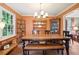 Inviting dining room with wood table, rustic furnishings, and natural light from a large window at 3025 Mountain Creek Ne Ct, Roswell, GA 30075