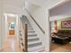 Inviting foyer with tiled flooring, stairs leading to the upper level, and views into the living room at 3025 Mountain Creek Ne Ct, Roswell, GA 30075