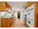 Well-lit kitchen with wooden cabinets, tiled floors, and modern appliances offering ample storage and functionality at 3025 Mountain Creek Ne Ct, Roswell, GA 30075