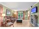 Cozy living room features a stone fireplace, hardwood floors, and large windows for natural light at 3025 Mountain Creek Ne Ct, Roswell, GA 30075
