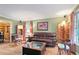Comfortable living room offers hardwood floors, warm lighting, and large windows at 3025 Mountain Creek Ne Ct, Roswell, GA 30075
