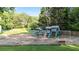 Community playground featuring slides and swings, set on a soft mulch surface with surrounding trees at 3025 Mountain Creek Ne Ct, Roswell, GA 30075