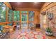 Relaxing screened-in porch with a red floral rug, string lights, comfortable seating and backyard views at 3025 Mountain Creek Ne Ct, Roswell, GA 30075