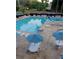 Inviting community swimming pool area with plenty of tables, chairs, and umbrellas for residents to relax and enjoy at 3025 Mountain Creek Ne Ct, Roswell, GA 30075