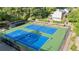 Aerial view of well-maintained tennis courts surrounded by lush greenery at 3025 Mountain Creek Ne Ct, Roswell, GA 30075