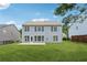 Well-maintained backyard features a spacious lawn, a patio and beautiful views of the house at 303 Ridgewood Trl, Canton, GA 30115