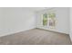 Bright bedroom with a window allowing natural light to fill the room and neutral carpet at 303 Ridgewood Trl, Canton, GA 30115