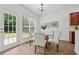 Bright breakfast nook with a glass table, wood floors, and backyard access at 303 Ridgewood Trl, Canton, GA 30115