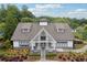 Inviting community clubhouse with attractive landscaping, a covered porch and a decorative roof at 303 Ridgewood Trl, Canton, GA 30115