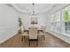 Elegant dining room featuring modern chandelier, large windows, and wood-look flooring at 303 Ridgewood Trl, Canton, GA 30115