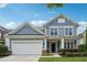 Charming two-story home with a well-maintained lawn and a classic suburban facade at 303 Ridgewood Trl, Canton, GA 30115