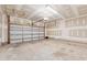 Spacious garage with an automatic door, ample lighting, and a concrete floor for parking at 303 Ridgewood Trl, Canton, GA 30115