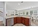 Kitchen with dark wood cabinets, granite countertops, and stainless steel dishwasher overlooking a living room at 303 Ridgewood Trl, Canton, GA 30115