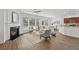 Open concept living room with fireplace, wood floors, and a view of the kitchen and breakfast nook at 303 Ridgewood Trl, Canton, GA 30115