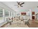 Bright living room showcasing hardwood floors, ceiling fan, and a stylish, modern design with chairs and sofa at 303 Ridgewood Trl, Canton, GA 30115