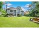 Expansive backyard featuring a patio, a fire pit, and lush green lawn at 3990 Madison Main Nw, Kennesaw, GA 30144