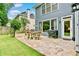 Inviting backyard patio with stone pavers, outdoor seating, and a grill for entertaining at 3990 Madison Main Nw, Kennesaw, GA 30144
