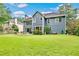 Large backyard with a well-maintained lawn, patio area, and mature trees at 3990 Madison Main Nw, Kennesaw, GA 30144