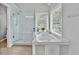 Bright bathroom boasts tile floors, separate glass enclosed shower, and soaking tub by the window at 3990 Madison Main Nw, Kennesaw, GA 30144