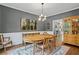 Formal dining room with hardwood floors, stylish furnishings, and access to the kitchen at 3990 Madison Main Nw, Kennesaw, GA 30144