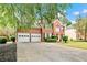 Attractive two-story brick home featuring a manicured lawn and a convenient two-car garage at 3990 Madison Main Nw, Kennesaw, GA 30144