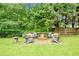 Picturesque backyard with a cozy fire pit area surrounded by mature trees at 3990 Madison Main Nw, Kennesaw, GA 30144