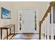 Bright foyer with white door, sidelights, console table, area rug, and staircase at 3990 Madison Main Nw, Kennesaw, GA 30144
