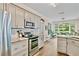 Bright kitchen with stainless steel appliances, modern cabinetry, and an adjacent breakfast nook at 3990 Madison Main Nw, Kennesaw, GA 30144