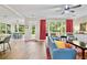 Open concept living room and dining area featuring hardwood floors, neutral tones, and natural light at 3990 Madison Main Nw, Kennesaw, GA 30144