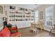 Spacious home office with a wall of bookshelves, comfortable seating, and a large window at 3990 Madison Main Nw, Kennesaw, GA 30144