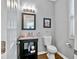 Stylish powder room features modern fixtures, elegant decor, and a granite countertop vanity at 3990 Madison Main Nw, Kennesaw, GA 30144