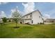 Spacious backyard showcasing a two-story home and green lawn on a sunny day at 7345 Vale Ct, Cumming, GA 30028