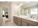 Bright bathroom featuring dual sinks, a large mirror, and a glass-enclosed shower at 7345 Vale Ct, Cumming, GA 30028