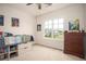 Cozy bedroom featuring a large window, built-in storage, and ample natural light at 7345 Vale Ct, Cumming, GA 30028