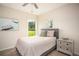 A cozy bedroom with artwork on the walls and a view of the outside at 7345 Vale Ct, Cumming, GA 30028