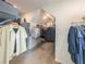 Walk-in closet with ample shelving, hanging rods, and storage space at 7345 Vale Ct, Cumming, GA 30028