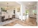 Open-concept dining room with hardwood floors, chandelier, and access to the living room at 7345 Vale Ct, Cumming, GA 30028