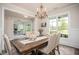 Elegant dining room featuring wood floors, wainscotting, and decorative lighting at 7345 Vale Ct, Cumming, GA 30028