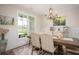 Charming dining room with a decorative chandelier and wainscotting at 7345 Vale Ct, Cumming, GA 30028