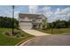 Beautiful two-story home with a gray roof, a large lawn, and a three car garage at 7345 Vale Ct, Cumming, GA 30028