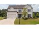 Charming two-story home with a neatly manicured lawn and a three car garage at 7345 Vale Ct, Cumming, GA 30028
