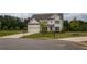 Beautiful two-story home with a gray roof, a large lawn, and a three car garage at 7345 Vale Ct, Cumming, GA 30028