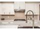 Kitchen features white cabinets, subway tile backsplash, stainless steel appliances, and a modern faucet at 7345 Vale Ct, Cumming, GA 30028