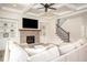 Bright living room with coffered ceilings, brick fireplace, built-in shelves, and a comfortable oversized sectional sofa at 7345 Vale Ct, Cumming, GA 30028