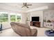 Bright living room with a ceiling fan, entertainment center, and view of the outdoors at 7345 Vale Ct, Cumming, GA 30028